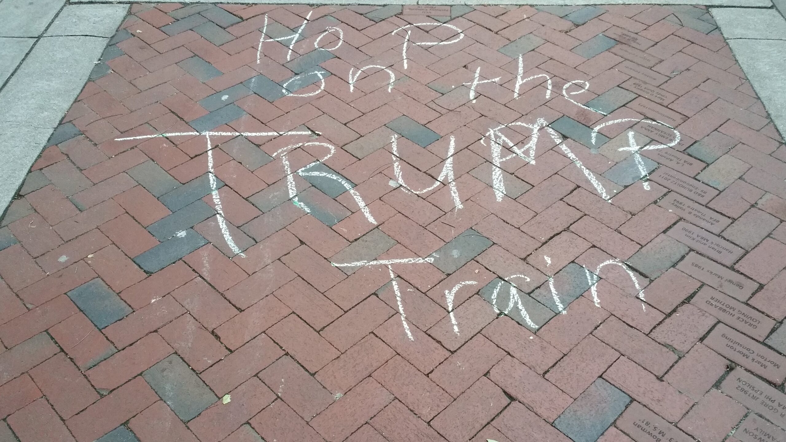 ‘Hop on the Trump train’ written in chalk on the pavement at Virginia Commonwealth University after the night of the 10 October 2016 presidential debate